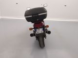 a red motorcycle parked in a white room