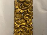 an ornate gold piece of art on display in a museum