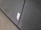 a sticker on the door of a car that is parked on the street