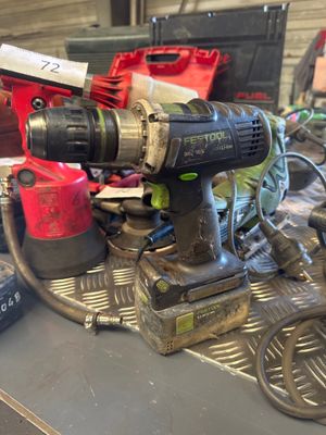 an image of a drill on a workbench in a garage