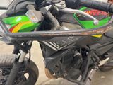 a green and black motorcycle parked in a garage