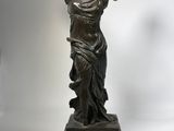 bronze statue of a woman holding a fan on a marble base