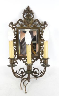 une photo d'une applique murale avec trois bougies et un miroir