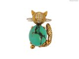 une image représentant un chat avec une pierre turquoise sur le dos