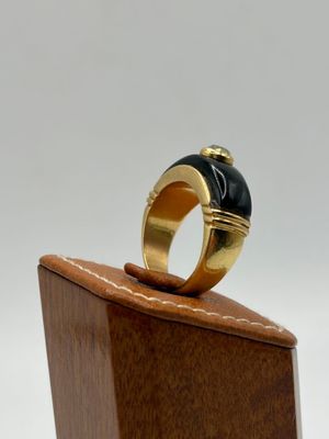 an image of a gold ring with a black stone on it