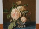 a painting of roses in a glass vase on a wooden easel