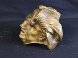 bronze bust of a man with a turban on his head