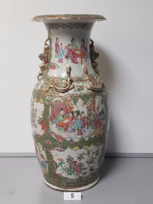 a large vase with a painting on it sitting on a table