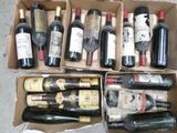 several bottles of wine are in a cardboard box on the floor