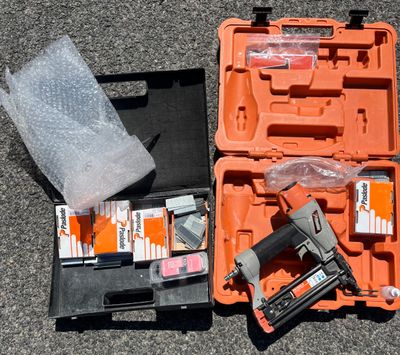 an orange case with a stapler and a stapler in it
