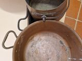 pots and pans are sitting on a stove top in a kitchen