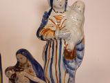 three ceramic figurines of a woman, a man and a child