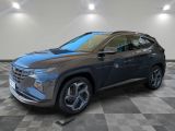 a gray 2021 hyundai kona suv parked in a showroom