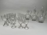 a lot of wine glasses and a pitcher on the table
