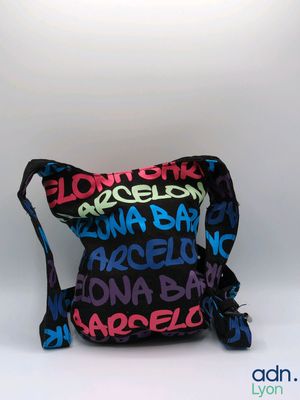 black and multicolored cross body bag with multicolored letters