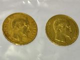 two gold sovereigns, one of which has a head of a man and one of which is a woman