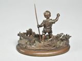 bronze figurine of a boy in a boat with a spear