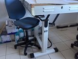 a desk with a chair and a computer on it