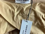 a close up of a label on a beige shirt