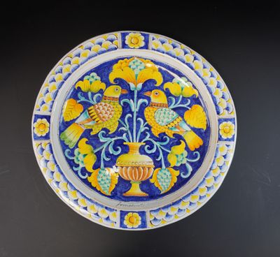 INNOCENTI. Grand plat en faïence à décor d'oiseaux dans le g…