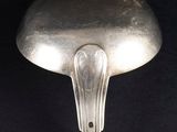 silver spoon on a black surface with a black background