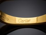 a close up of a gold ring with a name engraved on it