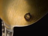 a metal spoon with a wooden handle on a black background