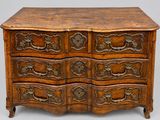 an old wooden chest of drawers with ornate carvings