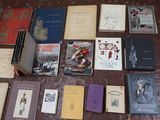 several books are laid out on a table on a carpet