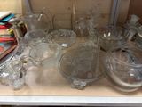 a lot of glassware on a shelf in a room