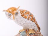 a figurine of an owl sitting on top of a rock