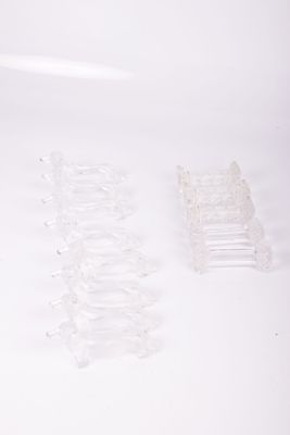 a lot of clear plastic chairs sitting on a white surface