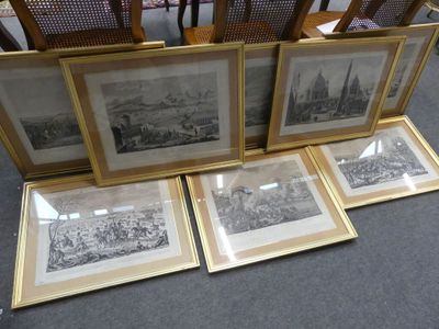 three framed pictures of a city and a chair in a room