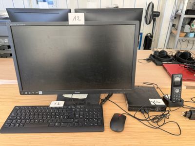 a computer monitor, keyboard, mouse, and other electronics on a desk