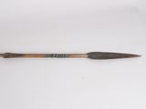 an old wooden spear with a long blade on a white surface