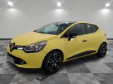 a yellow car is parked on a checkered floor in a garage