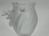 a glass vase with a horse on it on a table