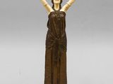 statue of a woman with her arms raised in the air