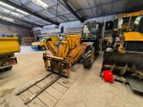 a large yellow truck parked in a garage
