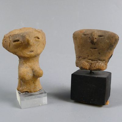 two figurines that are sitting next to each other