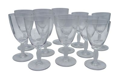 six clear wine glasses sitting on top of each other on a white surface