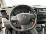 the interior of a car with a steering wheel and dashboard controls