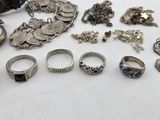 a lot of silver rings and bracelets sitting on a table
