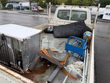 a truck that has a bunch of appliances in the back of it