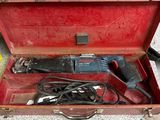 a red tool box with tools in it on the floor