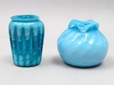 two blue vases sitting next to each other on a table