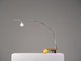 a lamp that is sitting on a table next to an orange