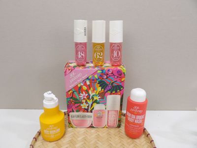 a basket with a lot of cosmetics and a bottle of liquid on it