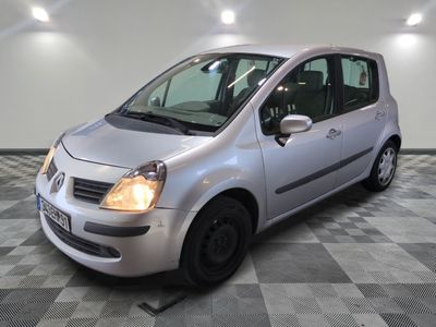a small silver car that is parked in a room