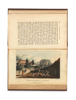 un livre ouvert sur lequel figure l'image d'un village et d'une calèche